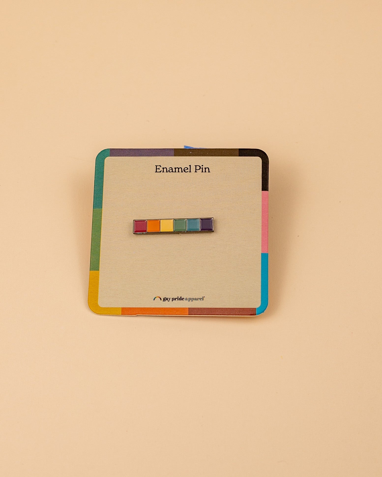 Enamel pin with rainbow-colored squares on a beige card with 'Enamel Pin' text, on a beige background
